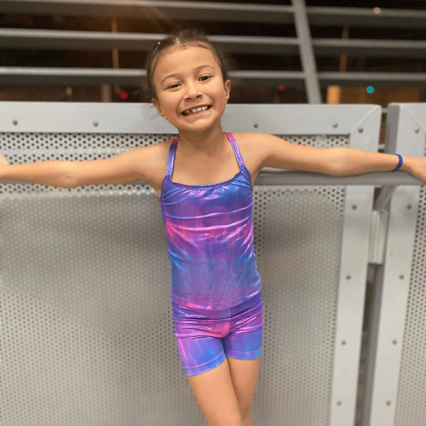 Front view of girl wearing Missty Mermaid Tails tie-dye coloured gymnastic out it