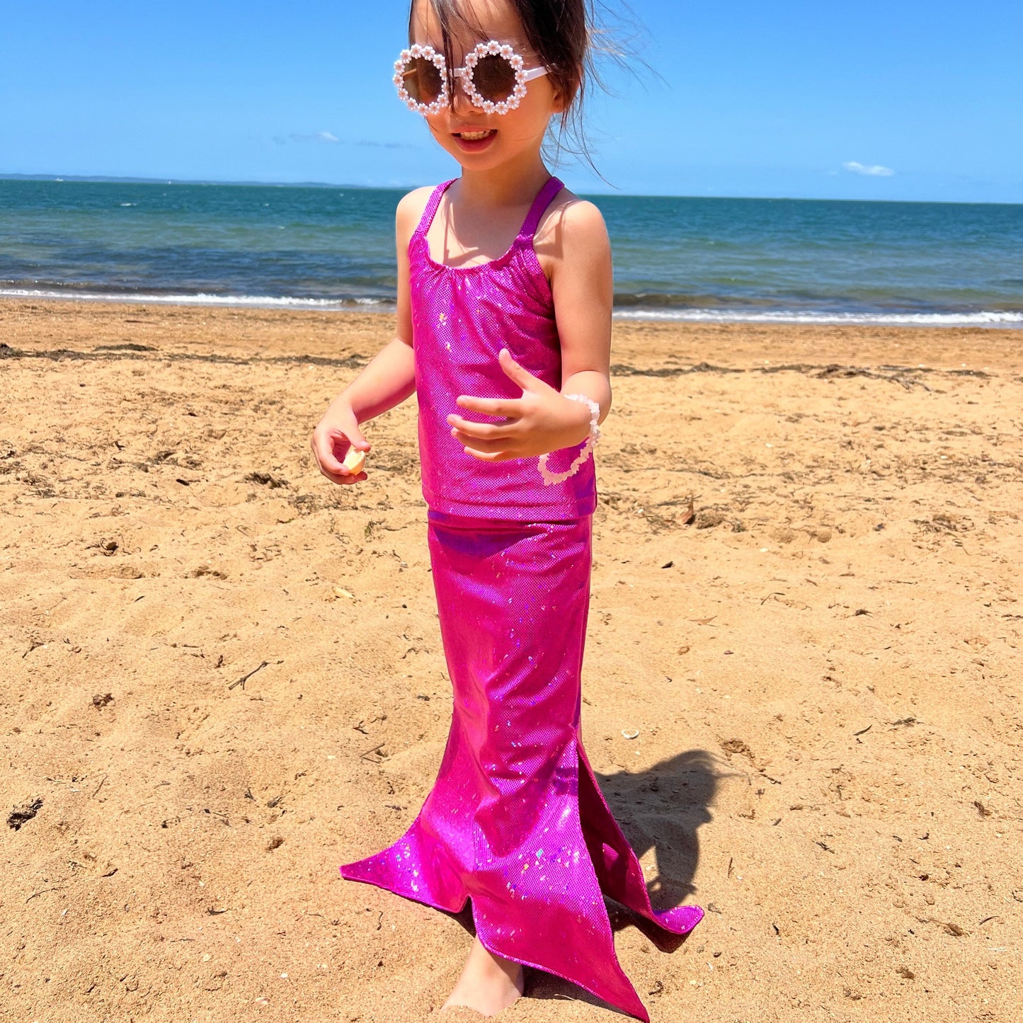 Girl wearing Missty Mermaid Tails pink mermaid tail and singlet