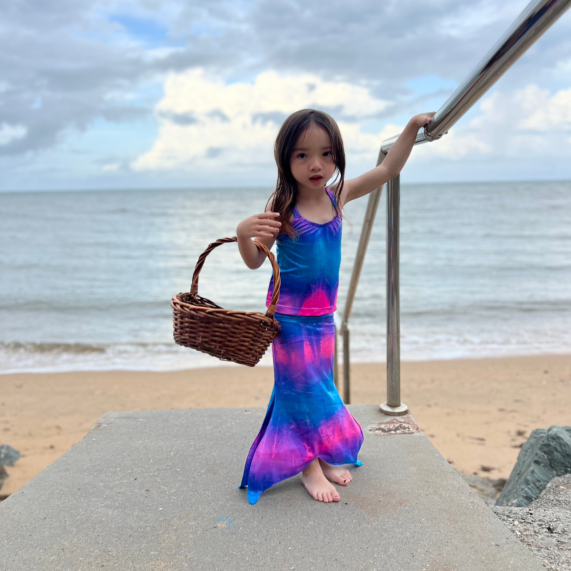 Girl wearing Missty Mermaid Tails tie-dye mermaid tail and singlet